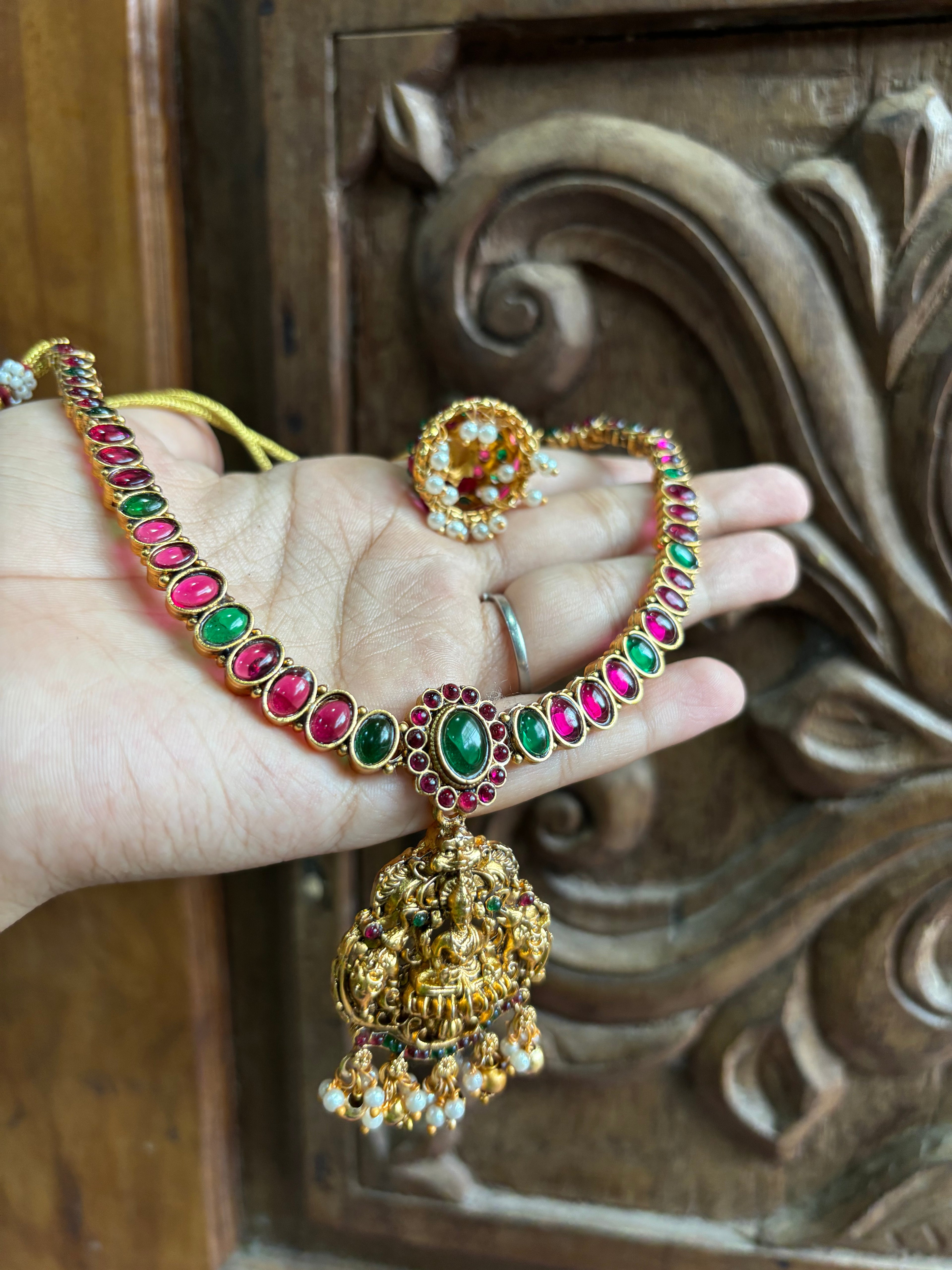 Red  with green stone adigai